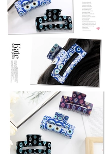 Detail of rectangular Evil Eye hair claws in blue, black, and purple acetate finish