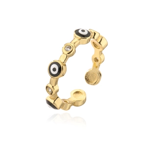 Detail of adjustable gold ring featuring enamel evil eye motifs and cubic zirconia