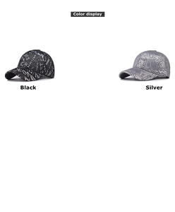 Detail of stylish baseball caps in black and silver with metallic graffiti patterns