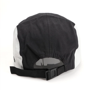 Five-panel baseball cap in black and white with adjustable back strap and embroidery