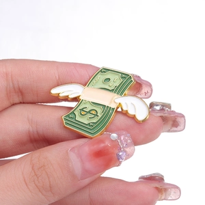Creative flying dollar bill enamel brooch with white wings and gold-plated metal edges