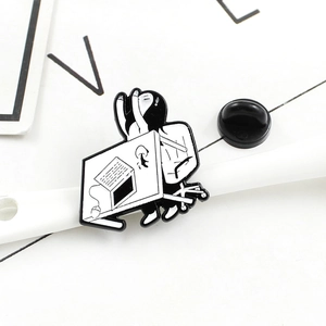 Detailed view of creative black and white enamel lapel pin with a cartoon character motif