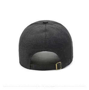 Detail view of dark gray baseball cap with adjustable bronze metal buckle at the back