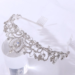 Detail of silver bridal tiara with sparkling rhinestones and side hair combs for weddings