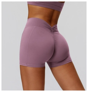 Detail of high waisted purple yoga shorts with scrunch seam and V-shaped back design