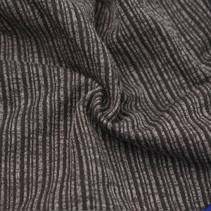 Detailed macro view of black and grey ribbed knit fabric texture on this beanie cap