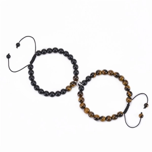 Detail of magnetic stone bracelets for couples featuring tiger eye and matte black beads