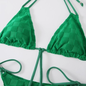 Detail of green bikini top with textured checkerboard fabric and adjustable tie straps