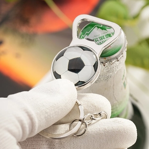 Close-up of football patterned alloy keychain bottle opener opening a Harbin beer bottle