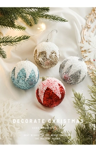 Détail de boules de Noël scintillantes en mousse rouge et or sur un fond festif cosy