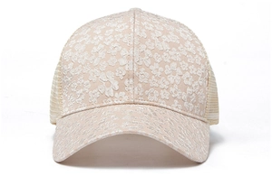 Detailed view of beige floral lace embroidery and breathable mesh on a baseball cap