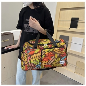 Travel tote bag featuring colorful leaf prints and large capacity for gym or weekend trips