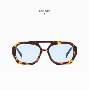 Detail of geometric double-bridge sunglasses with demi frame and light blue lenses