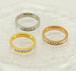 Detailed view of silver gold and rose gold eternity rings with cubic zirconia stones