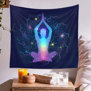 Chakra yoga meditation tapestry on white wall with candle and wooden furniture detail