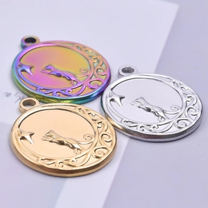 Macro detail of heart-shaped cat on moon pendants in gold, silver, and rainbow steel