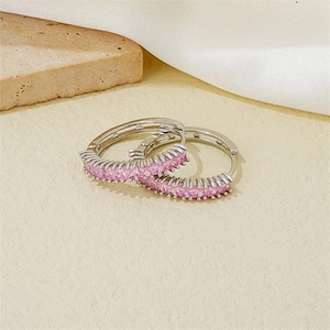 Detailed macro view of S925 silver hoop earrings featuring pavé-set pink square zircons