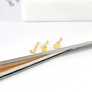 Macro detail of gold S925 sterling silver moon star and heart stud earrings set
