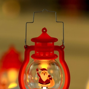 Close-up of red Christmas LED lantern with Santa Claus pattern and warm glow