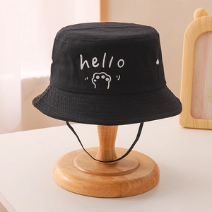 Detail of black cotton kids bucket hat featuring white hello embroidery and chin strap