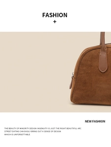 Detail shot of brown suede bowling bag featuring leather handles and smooth zipper closure