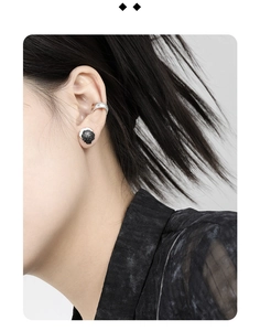 Detail view of S925 sterling silver earring and ear cuff on model with irregular texture