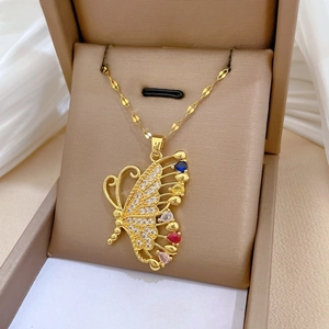 Detailed shot of golden butterfly pendant with multi-color pear-cut stones and crystal pave