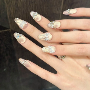 Pink aurora cat eye almond press-on nails with 3D white bow and pearl accents