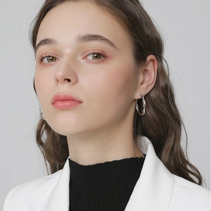 Minimalist silver twist hoop earrings for women with a polished metallic finish and spiral texture
