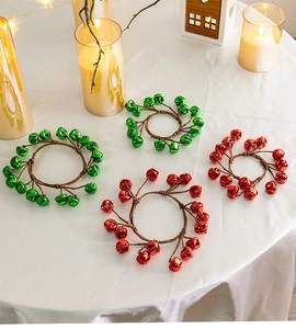 Close-up of festive Christmas bell rings in red and green on a white silk tablecloth