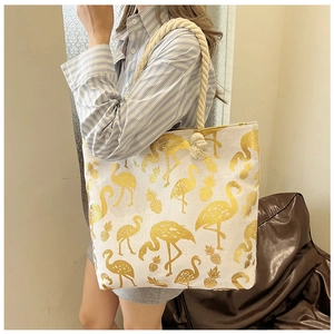 Close-up of canvas tote bag with gold flamingo print and thick hemp rope handle