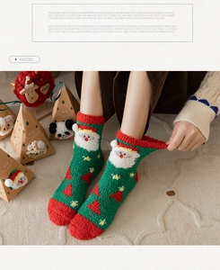 Detail of soft coral fleece Christmas socks featuring Santa Claus and tree patterns