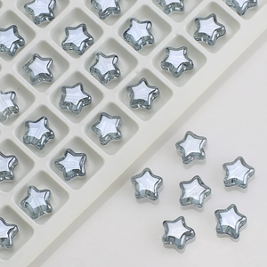 Macro view of transparent gray star glass beads for DIY jewelry and hair accessories