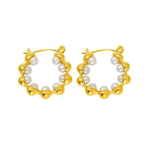 Detail showing high-polish gold hoop earrings with small white pearls on white background