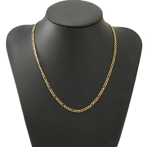 Golden stainless steel Figaro chain necklace displayed on a black mannequin stand