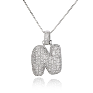 Detailed close-up of a silver bubble letter N pendant necklace with micro-pave cubic zirconia