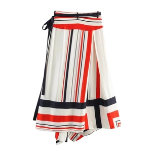 Detail of silk-like satin midi skirt with geometric stripes and waist tie design
