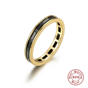 Macro detail of S925 sterling silver ring with black rectangular stones in gold finish