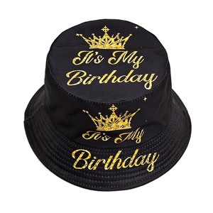 Reversible black cotton bucket hat with golden Birthday crown print and sun protection