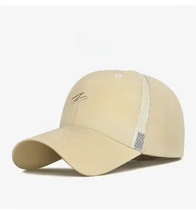 Detail of breathable side mesh and gold embroidery on beige quick-dry baseball cap