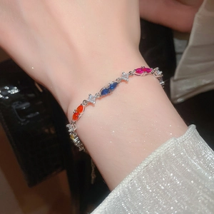 Close-up of sparkling colorful marquise and square cut gemstone bracelet on woman's wrist