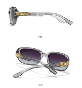 Detail view of transparent grey pilot sunglasses featuring gold star-embossed hinges