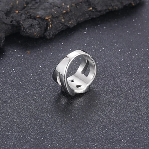 Detail of silver chain-link pattern on wide polished stainless steel ring