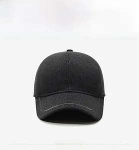 Front view of dark grey winter baseball cap showing thick knit texture and side logo