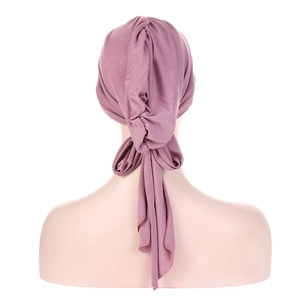 Detail view of purple pleated headscarf with long tie ribbons on a mannequin back