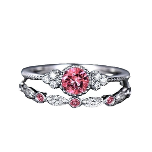 Two-piece silver ring set featuring a round pink center stone and sparkling side crystals