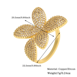 Detailed view of golden flower ring with micro-pave zircons including weight and size specs