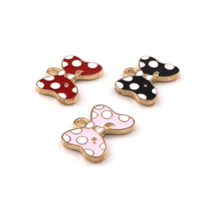 DIY colorful polka dot bow charms in red, black, and pink with gold metal edges