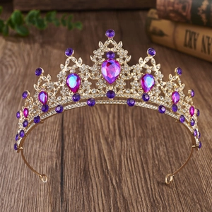 Detailed close-up of Baroque gold crown with large purple teardrop crystals and rhinestones