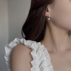 Elegant 925 sterling silver hoop earrings with natural freshwater pearls on a model